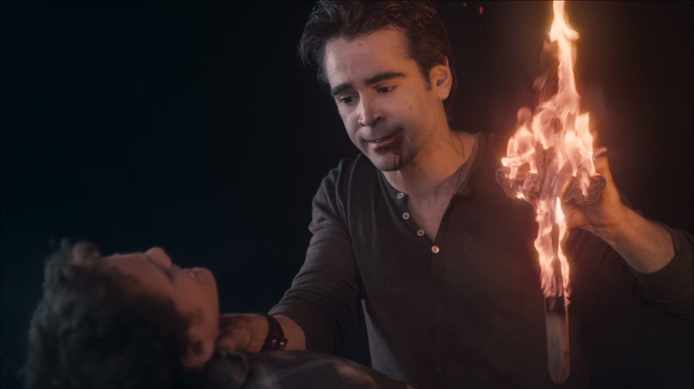 His hands burning, the vampire Jerry (Colin Farrell) rips away the cross that Charley (Anton Yelchin) unsuccessfully tried to protect himself with in Fright Night, the Craig Gillespie-helmed revamp of the comedy-horror classic. © DreamWorks. All Rights Reserved.