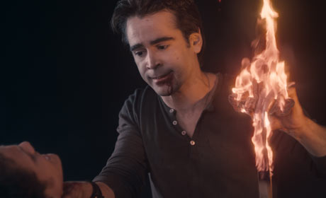 His hands burning, the vampire Jerry (Colin Farrell) rips away the cross that Charley (Anton Yelchin) unsuccessfully tried to protect himself with in Fright Night, the Craig Gillespie-helmed revamp of the comedy-horror classic. © DreamWorks. All Rights Reserved.